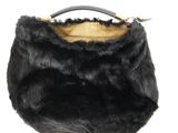 the black fur purse is on a white surface