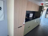 an image of a kitchen with a tv on the wall