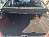 the back of a car with the trunk open and the seat folded down