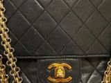a black chanel bag with gold hardware and chain