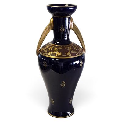 a blue vase with a gold decoration on it