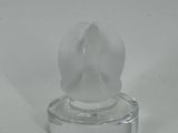 a clear glass object with a flower on it
