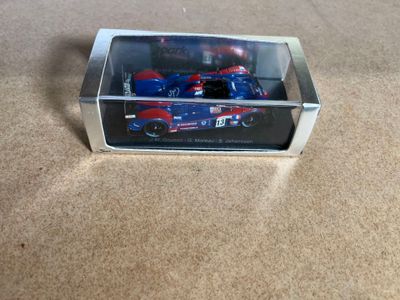 a toy car in a clear box on the floor