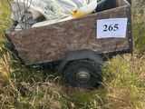 a wooden cart filled with garbage on the side of a hill