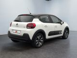 the rear of a white car parked in a garage