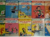 six bandes dessinées pour enfants sont alignées sur un mur