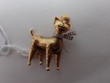 a gold dog with a bow tie on a chain