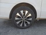 a close up of a tire on a white car