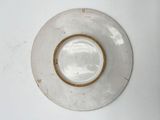 a white plate with a brown rim on a white table