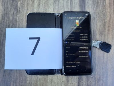 a black phone with a number 7 on it next to a white card