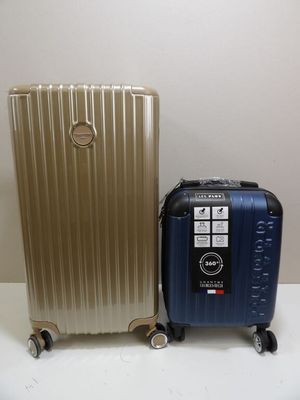 two pieces of luggage sitting next to each other on a table