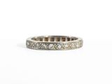 a close up of a diamond ring on a white surface
