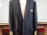 a suit and tie on a mannequin stand in front of a table