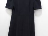 the back of a black dress hanging on a hanger