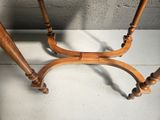 a wooden table with a marble top and two wooden legs