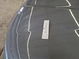 a sticker on the hood of a car that is parked in a garage