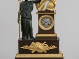 a statue of a man holding a sword and a clock