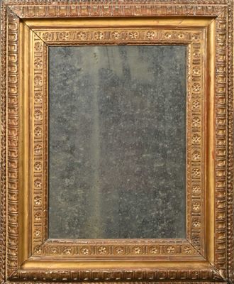 an antique gold framed mirror with ornate design on a wall