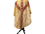 an image of a gold and red dress on a mannequin stand