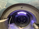 a close up view of a blue light in a metal object