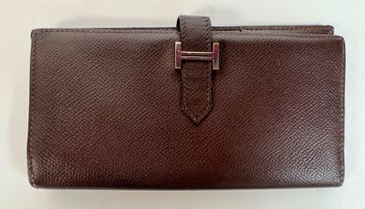 brown leather wallet with a metal clasp on the front