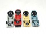 four toy trucks sitting side by side on a white surface
