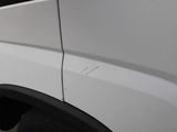 a close up of a white van with a hole in the side of it