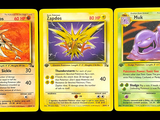 three pokemon cards with different designs on them on a black background