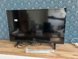 a flat screen tv sitting on top of a wooden table