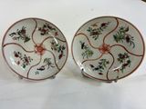 pair of chinese plates with floral designs on them on a white surface