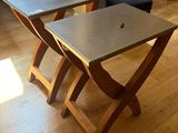 two tables that are sitting on a wooden floor