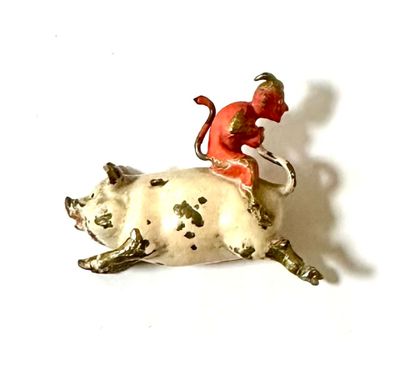 a figurine of a man riding a cow on a white background