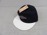 the hat is black and white and has a tag on it