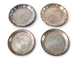 three silver dishes on a white surface with a white background