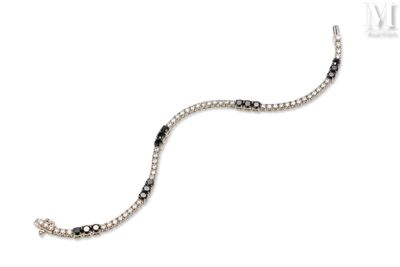 a close up of a bracelet with black and white stones on it