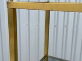 a close up of a metal shelf with a glass top