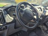 a baby sitting in the driver ' s seat of a car