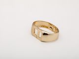 a close up of a gold ring on a white surface