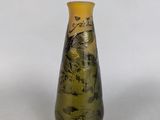 a small vase with a painting on it on a table