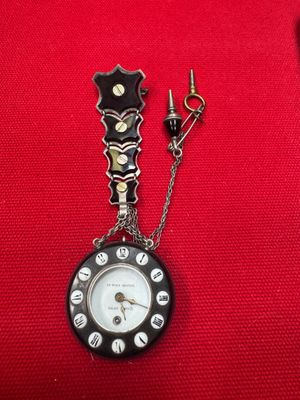 a black and white clock with a chain attached to it