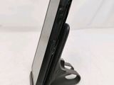 a cell phone that is on a stand on a table