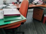 a desk with a lot of papers on top of it