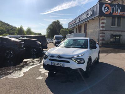 a white car that is parked in front of a building