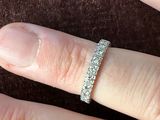 a close up of a person ' s hand with a diamond ring on it