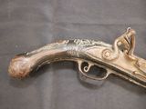 an old gun that is on display on a table