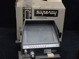 a small television sitting on top of a table next to a box