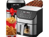 an air fryer with a basket of french fries and a glass of coke