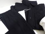 a pair of black pants and a white shirt on a table