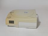 a small video game console sitting on a white surface
