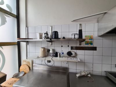 a picture of a kitchen with stainless steel counter tops